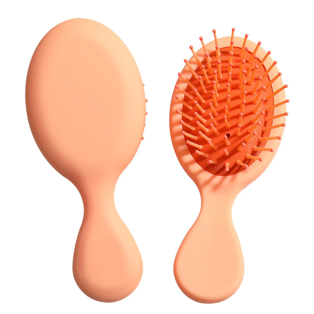 Stylish orange Mini Detangler Hair Brush by Organic Cecret, suitable for kids and adults for easy hair management.