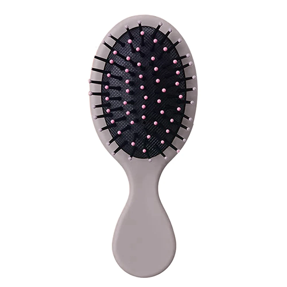 Earthy brown Mini Detangler Hair Brush by Organic Cecret, a perfect addition to your daily hair care routine.