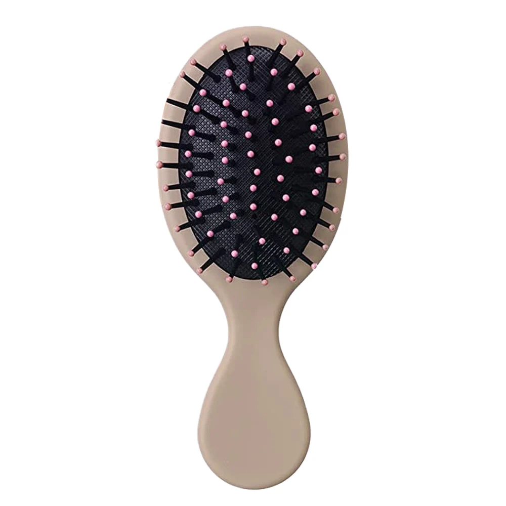 Earthy brown Mini Detangler Hair Brush by Organic Cecret, a perfect addition to your daily hair care routine.