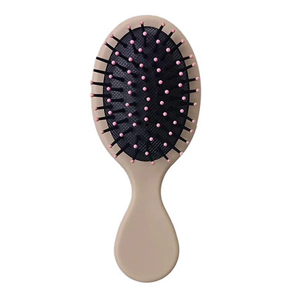 Earthy brown Mini Detangler Hair Brush by Organic Cecret, a perfect addition to your daily hair care routine.