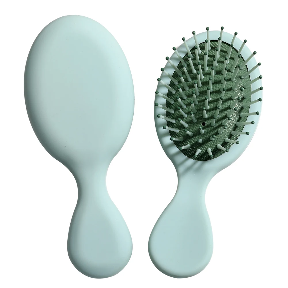 Refreshing green Mini Detangler Hair Brush by Organic Cecret, easy to carry and perfect for daily hair care.