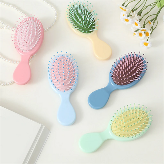 Compact and travel-friendly Mini Detangler Hair Brush by Organic Cecret, designed to glide through knots smoothly without breakage.