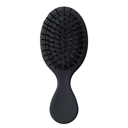 Compact and travel-friendly Mini Detangler Hair Brush by Organic Cecret, designed to glide through knots smoothly without breakage.
