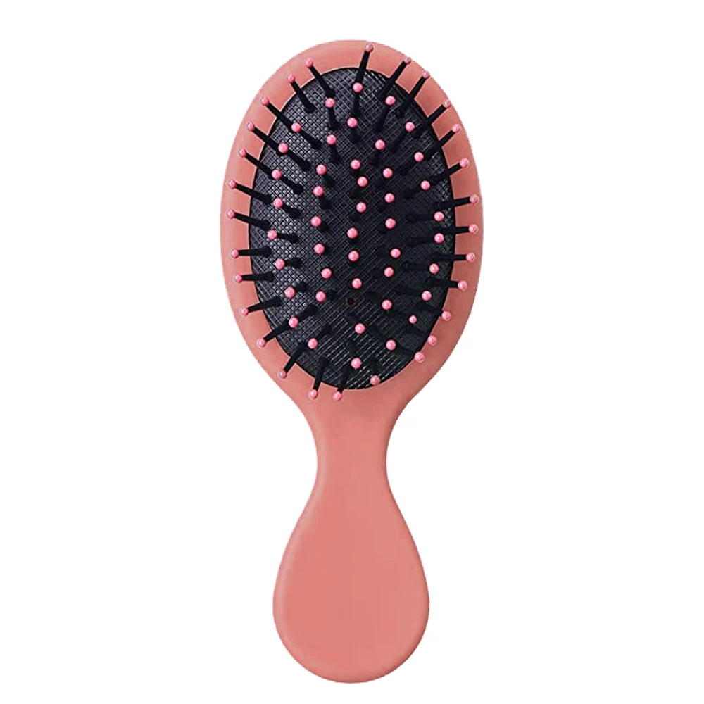 Soft pink Mini Detangler Hair Brush by Organic Cecret, perfect for smooth and tangle-free hair.