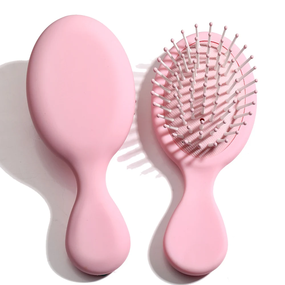 Soft pink Mini Detangler Hair Brush by Organic Cecret, perfect for smooth and tangle-free hair.