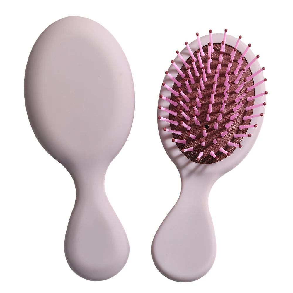 Purple Mini Detangler Hair Brush by Organic Cecret, lightweight and ideal for all hair types.

