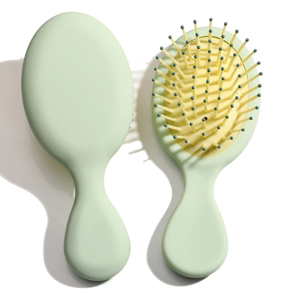 Bright yellow Mini Detangler Hair Brush by Organic Cecret, gently glides through knots for pain-free brushing.