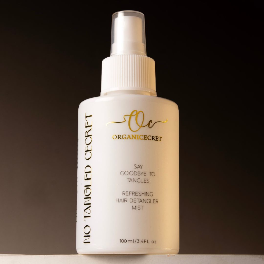 A bottle of No Tangled Cecret Refreshing Hair Detangler Mist, placed on a sleek surface with a soft glow, highlighting its lightweight, frizz-free, and nourishing benefits for smooth, tangle-free hair