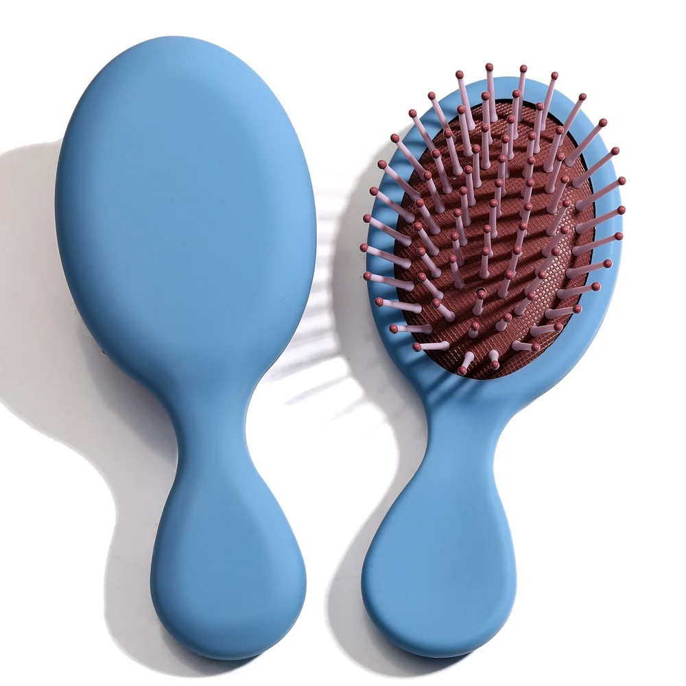 Blue Mini Detangler Hair Brush by Organic Cecret, designed for gentle detangling with minimal breakage.
