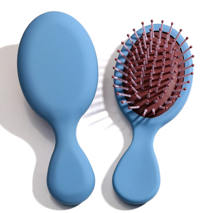 Blue Mini Detangler Hair Brush by Organic Cecret, designed for gentle detangling with minimal breakage.