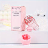 Pink scalp and hair oil applicator with packaging on a white background